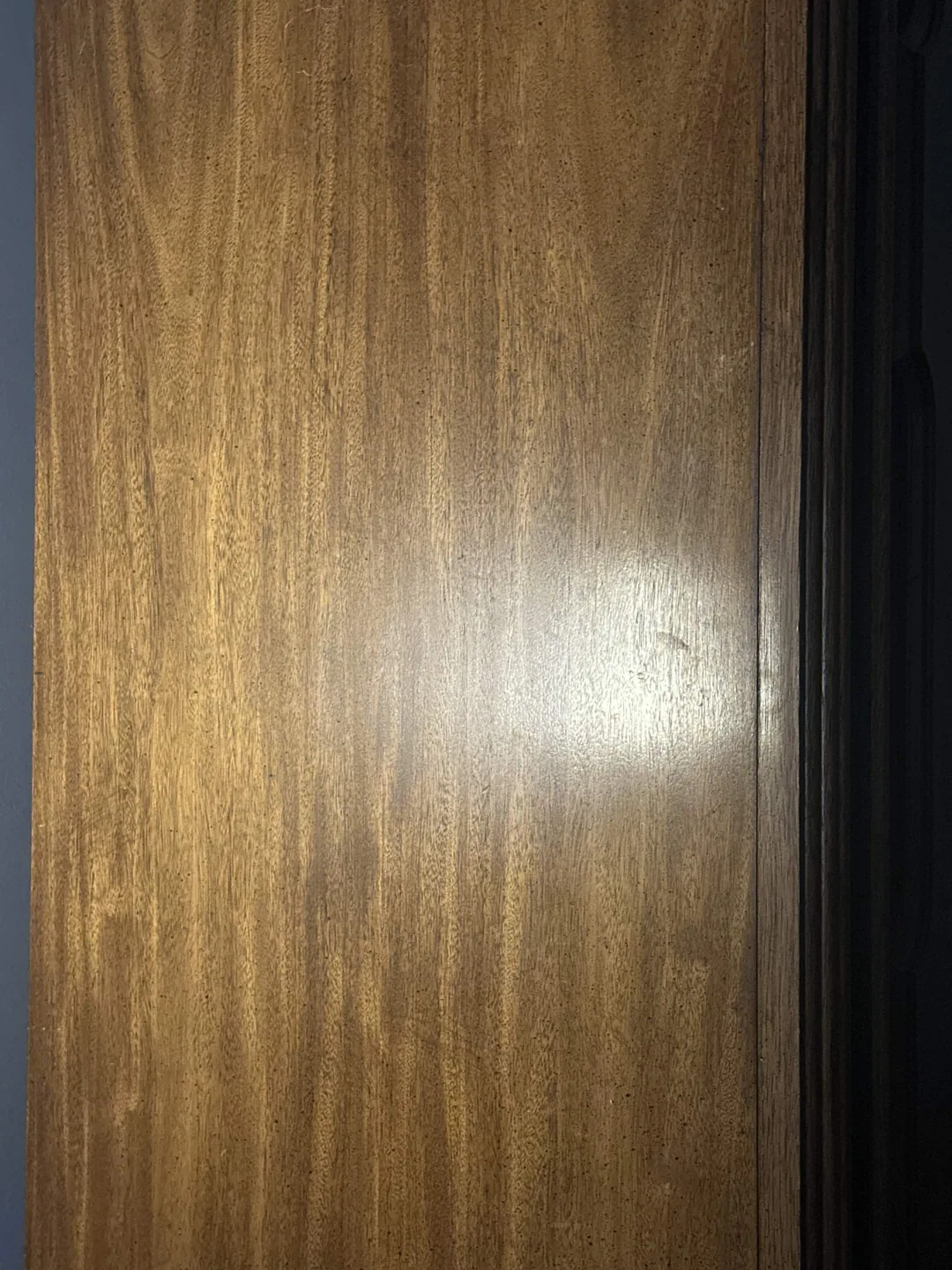 Phone photo of a wood door with uneven lighting before texture extraction